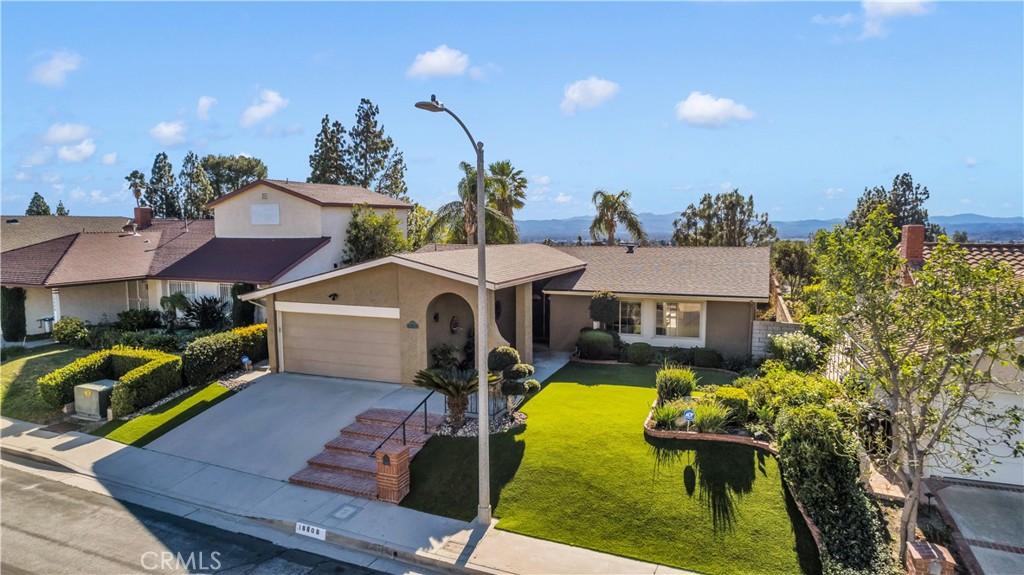 ranch-style house with a garage and a front lawn