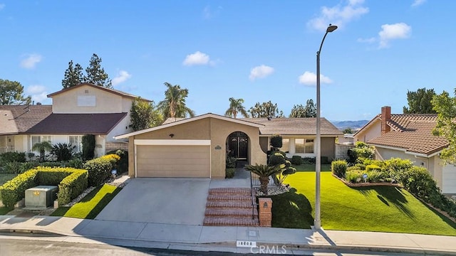 view of front facade with a front yard and a garage