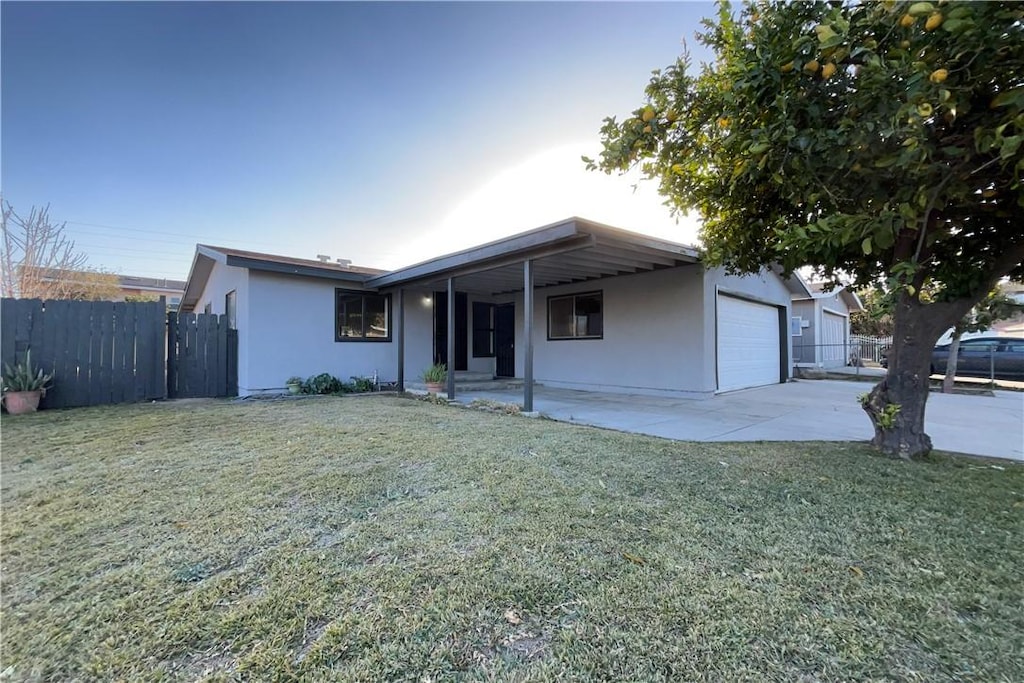 single story home featuring a front yard and a garage