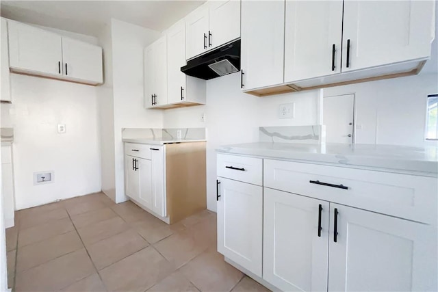 kitchen with light tile patterned floors and white cabinets