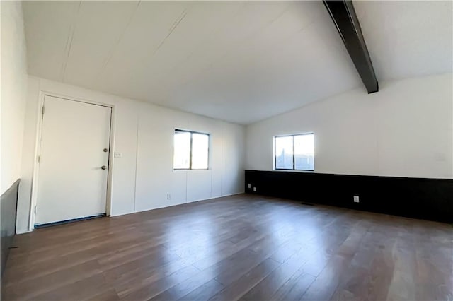 unfurnished room featuring dark hardwood / wood-style flooring and lofted ceiling with beams