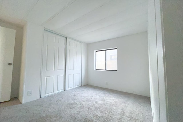 unfurnished bedroom featuring a closet and carpet floors