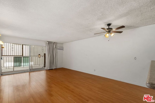 spare room featuring ceiling fan, a textured ceiling, and hardwood / wood-style flooring