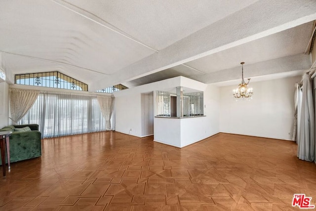 unfurnished living room with a chandelier, lofted ceiling, and parquet flooring