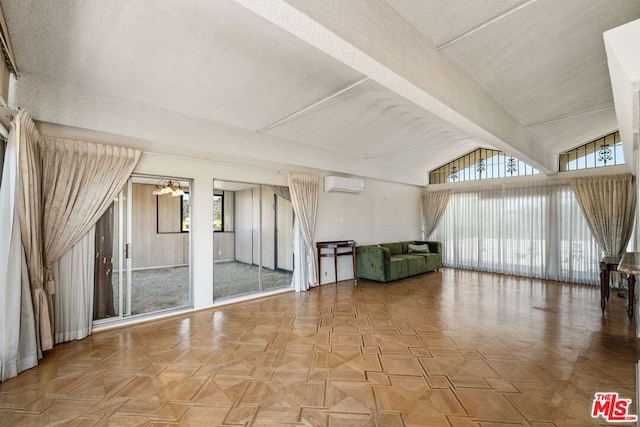 interior space featuring light parquet flooring, an AC wall unit, vaulted ceiling, and a notable chandelier