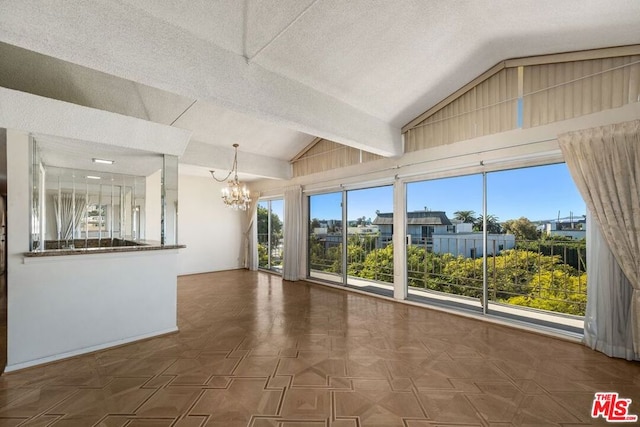 interior space with a wealth of natural light, lofted ceiling, dark parquet floors, and an inviting chandelier