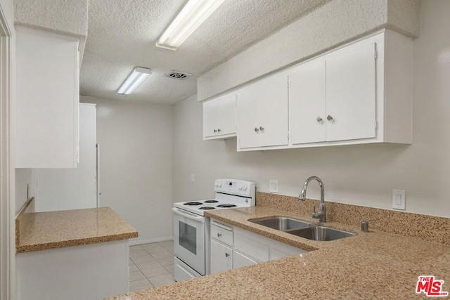 kitchen featuring white range with electric stovetop, sink, white cabinetry, a textured ceiling, and light tile patterned floors