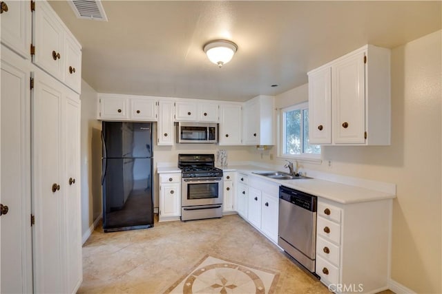 kitchen with stainless steel appliances and white cabinets