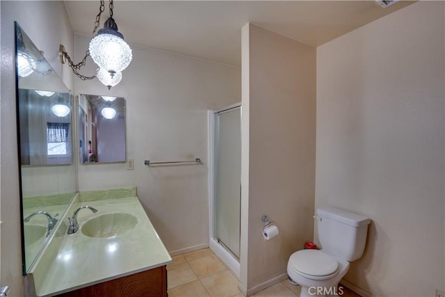 bathroom with toilet, vanity, tile patterned flooring, and a shower with door