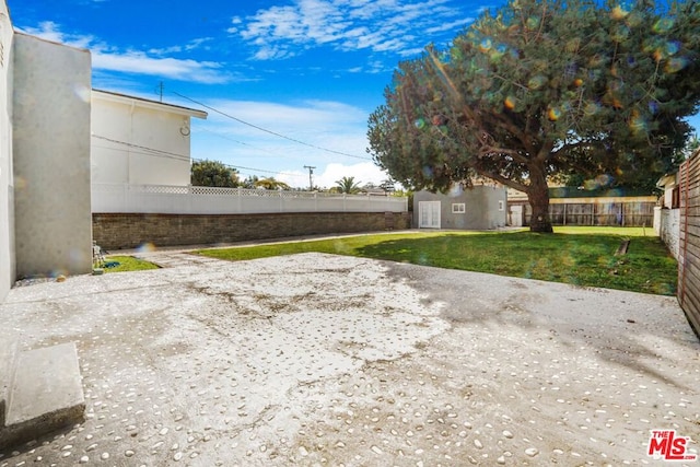 view of yard with an outbuilding and a patio