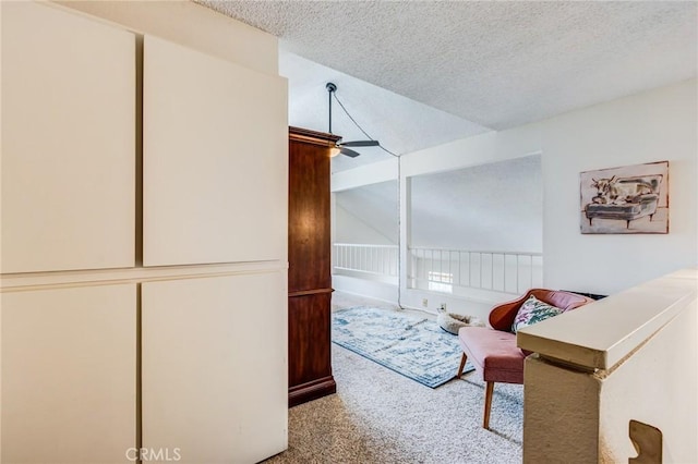 carpeted bedroom featuring lofted ceiling and a textured ceiling