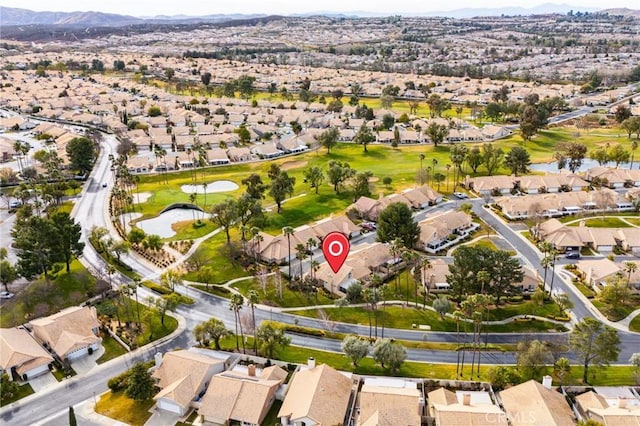 aerial view with a residential view, golf course view, and a water and mountain view