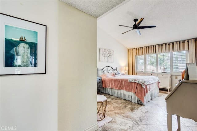 bedroom featuring ceiling fan, vaulted ceiling, and a textured ceiling