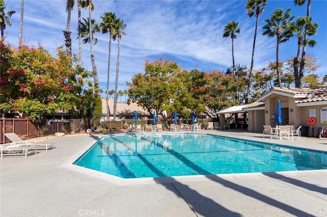 pool featuring fence and a patio