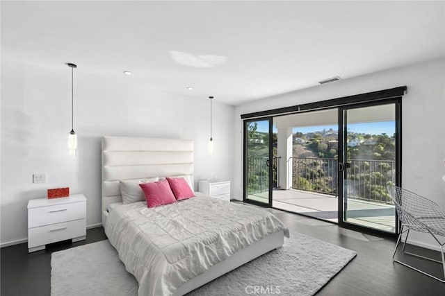 bedroom featuring access to exterior and dark hardwood / wood-style flooring