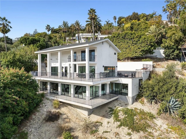 rear view of property featuring a balcony