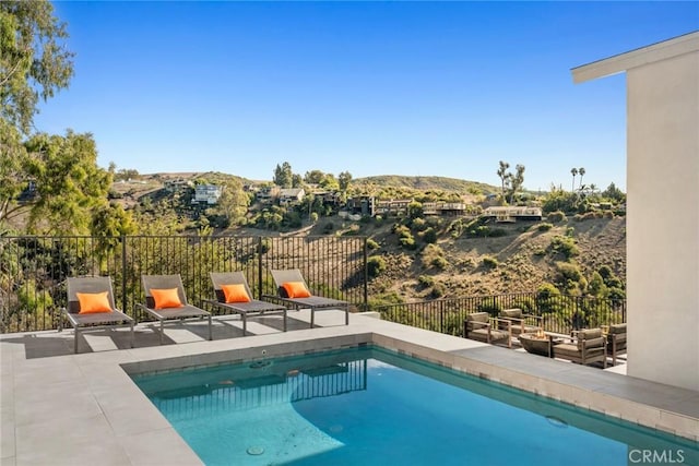 view of pool featuring a mountain view and a patio