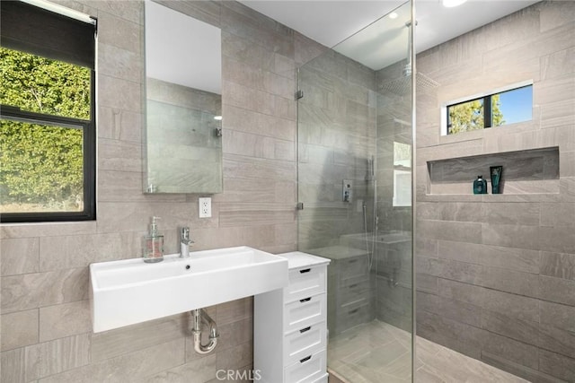 bathroom with sink and a shower with shower door