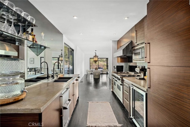 kitchen with sink, beverage cooler, wall chimney exhaust hood, and appliances with stainless steel finishes