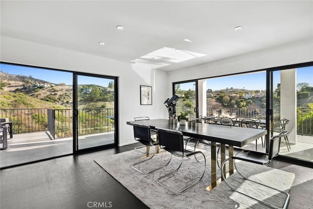 dining area featuring a wealth of natural light and dark hardwood / wood-style flooring