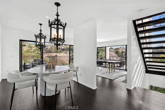 dining room with an inviting chandelier and dark hardwood / wood-style floors