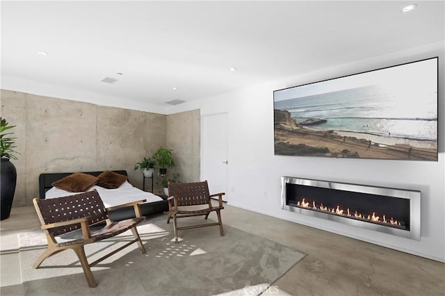 living area with concrete floors