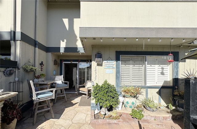 entrance to property featuring a patio area