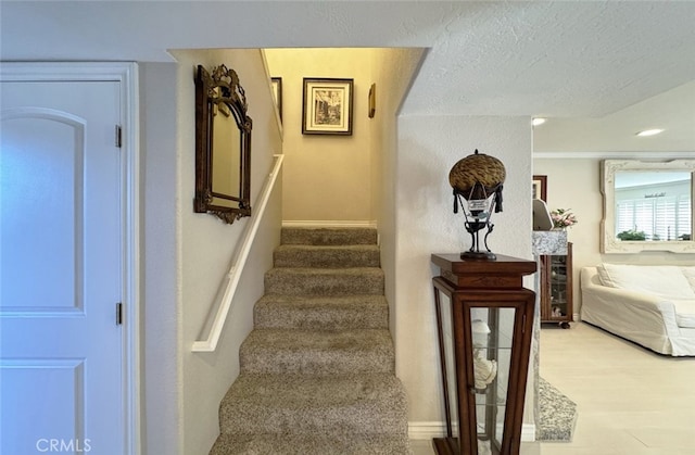 stairs with a textured ceiling