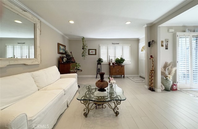 living room with crown molding and light hardwood / wood-style floors