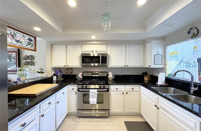 kitchen featuring white cabinets, sink, a tray ceiling, and stainless steel appliances