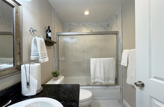 full bathroom with toilet, combined bath / shower with glass door, and vanity