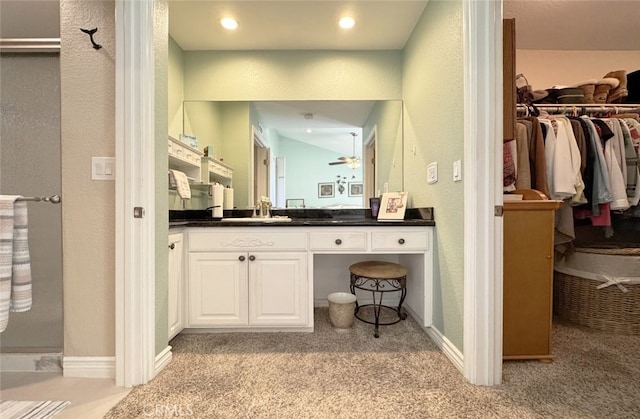 bathroom with ceiling fan and vanity