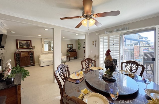 dining area featuring ceiling fan and ornamental molding