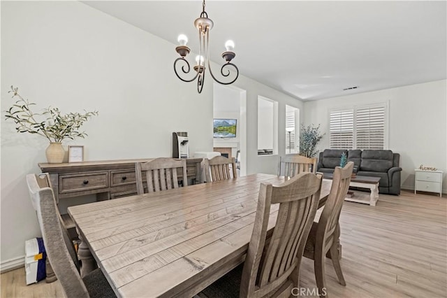 dining room featuring an inviting chandelier and light hardwood / wood-style floors