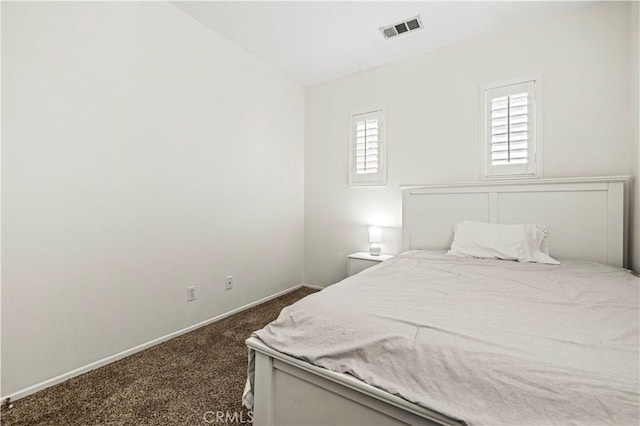 bedroom featuring dark carpet