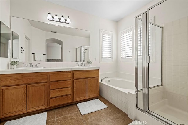 bathroom featuring tile patterned flooring, vanity, and independent shower and bath