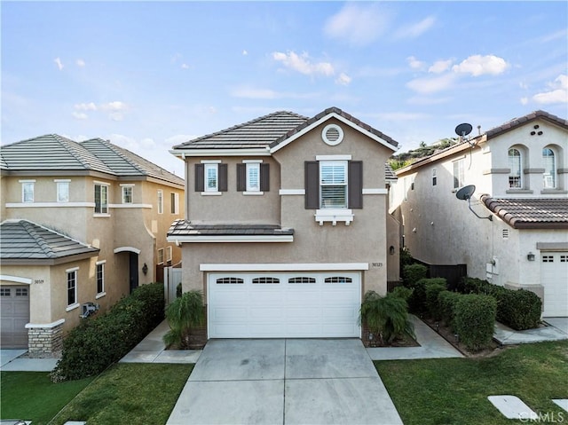 view of front property featuring a garage and a front yard