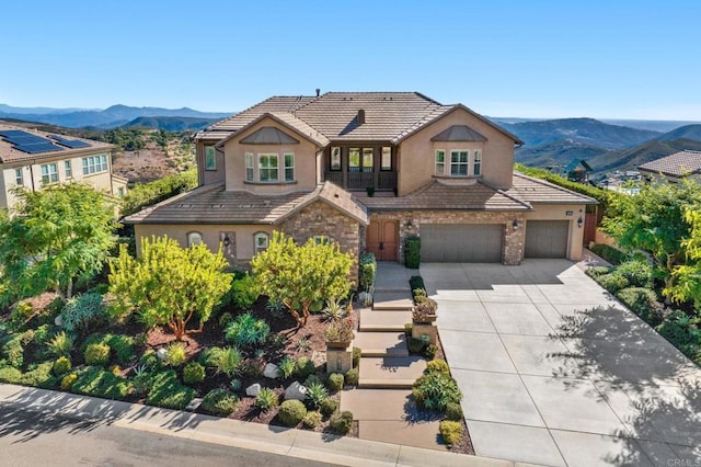 view of front facade with a garage and a mountain view