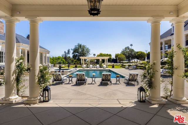 view of swimming pool featuring a pergola and a patio