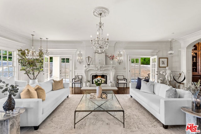 living room with french doors and crown molding