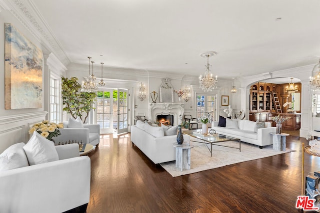 living room featuring hardwood / wood-style floors, crown molding, and french doors