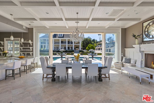 dining room featuring an inviting chandelier, a wealth of natural light, and beamed ceiling