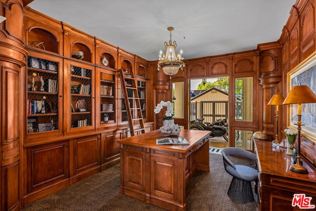 carpeted office space featuring a notable chandelier