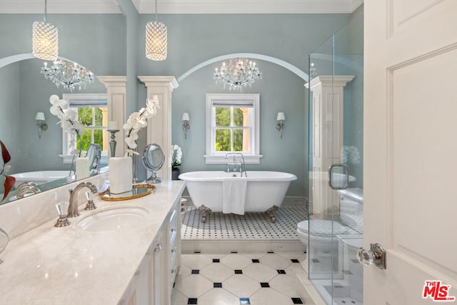 bathroom featuring plus walk in shower, an inviting chandelier, vanity, and decorative columns