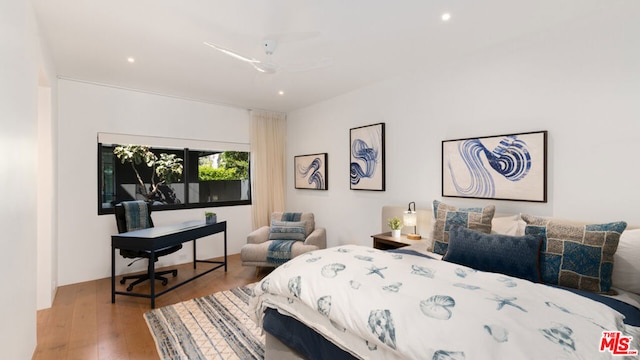 bedroom with ceiling fan and light hardwood / wood-style flooring