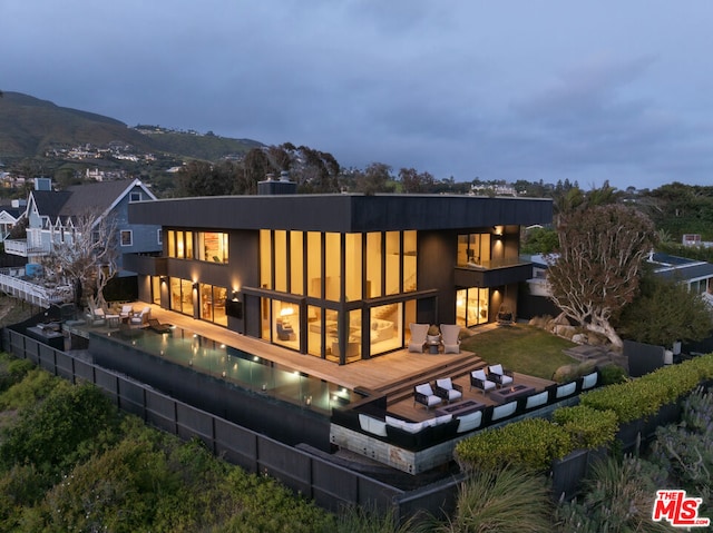 rear view of house with a patio area and a pool