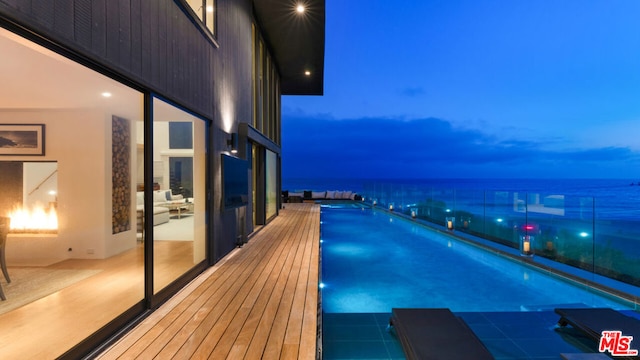 pool at dusk with a water view