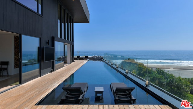 view of swimming pool featuring a water view