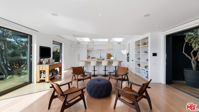 interior space featuring light hardwood / wood-style floors and built in shelves