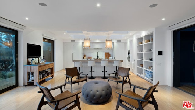 interior space featuring built in features and light hardwood / wood-style floors